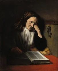 Une vieille femme somnolant sur un livre
