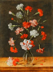 Œillets dans un vase en verre sur une table en pierre