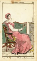Femme assise sur une chaise Empire dans un salon, Paris
