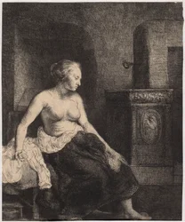 Une femme à demi nue assise près du poêle