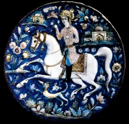 Art iranien : plat en céramique polychrome représentant un cavalier. 16ème siècle