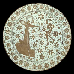 Dame tirant un arc sur un jeune homme dont le cou est traversé par une flèche. Plat en faïence de production espagnole. 16ème siècle Paris, Musée du Louvre