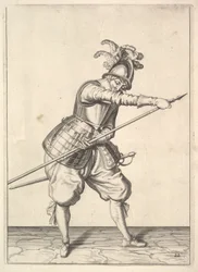 Un soldat glissant sa main droite le long de la pique d