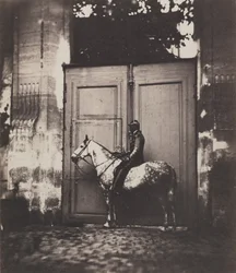 Cavalier noir devant une porte, vers 1855.