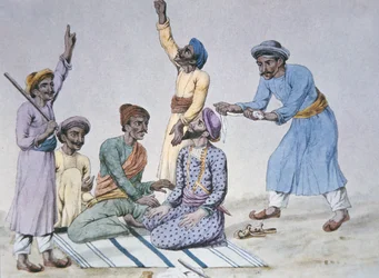 Un groupe de Thugs se préparant à étrangler une victime (lithographie en couleur)