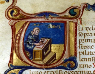 Moine copiste dans son scriptorium, enluminure