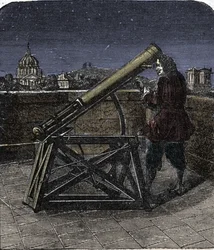 Isaac Newton (1642-1727) physicien anglais utilisant son télescope