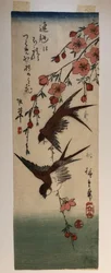 Deux hirondelles et une branche de pommier en fleurs