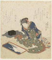 Femme faisant une peinture de sable