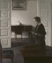 Intérieur avec une dame lisant, vers 1900