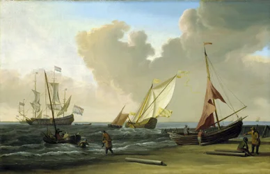 Bateau de pêche tirant ses filets sur la plage dans le vent, sur la côte hollandaise